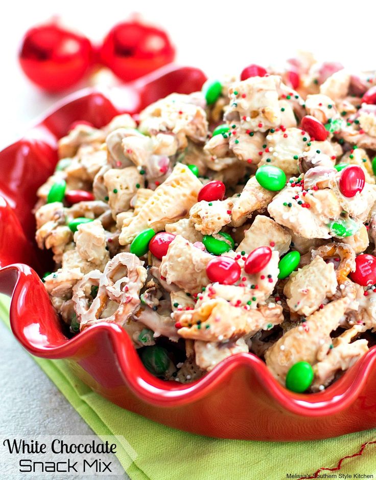 a red bowl filled with food on top of a green plate next to cherries