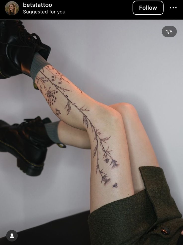 a woman's legs with tattoos on them