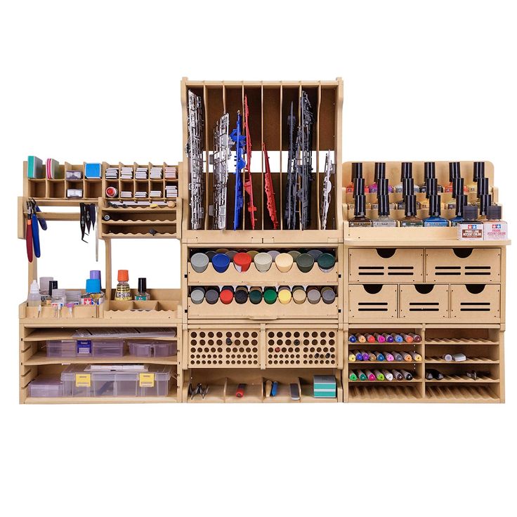 an assortment of crafting supplies displayed on wooden shelves with bins and dividers