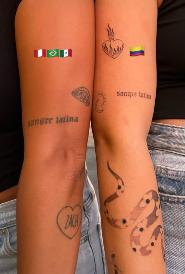 two people with tattoos on their arms, one has a heart and the other has an italian flag