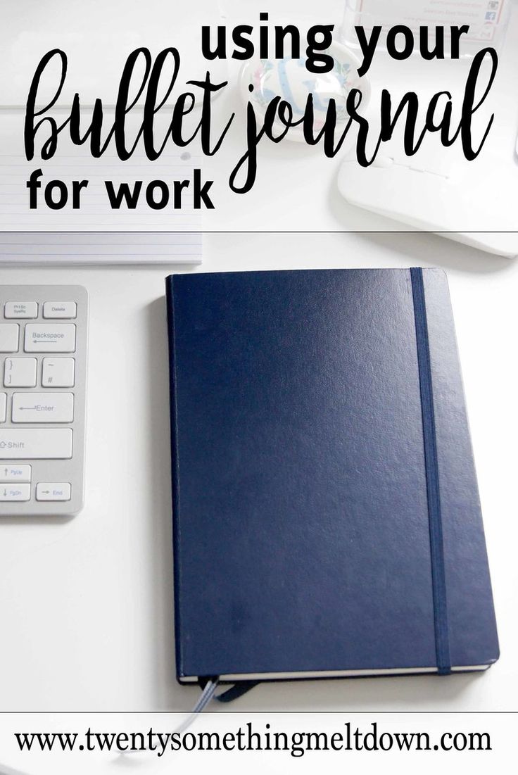 a blue notebook sitting on top of a white desk next to a keyboard and mouse