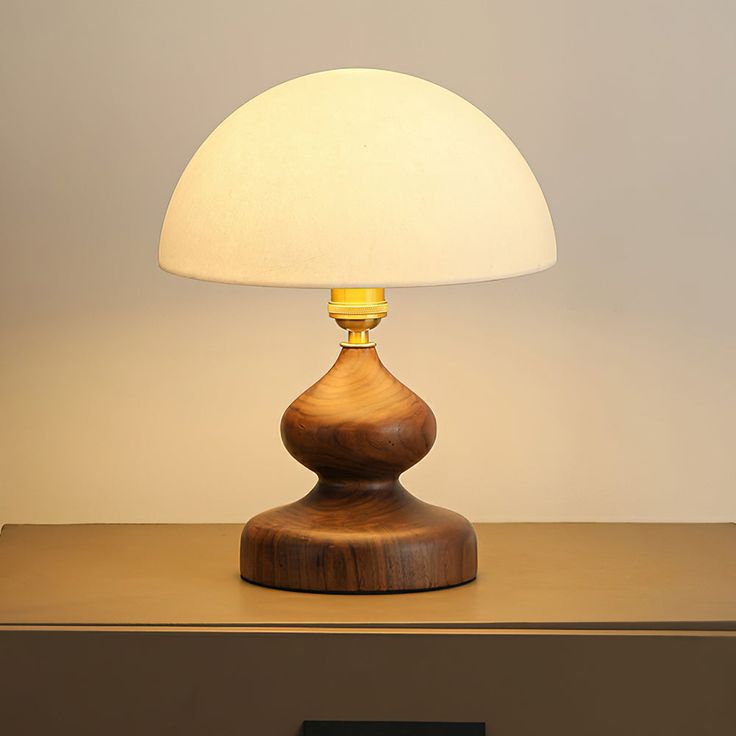 a wooden table with a lamp on top of it