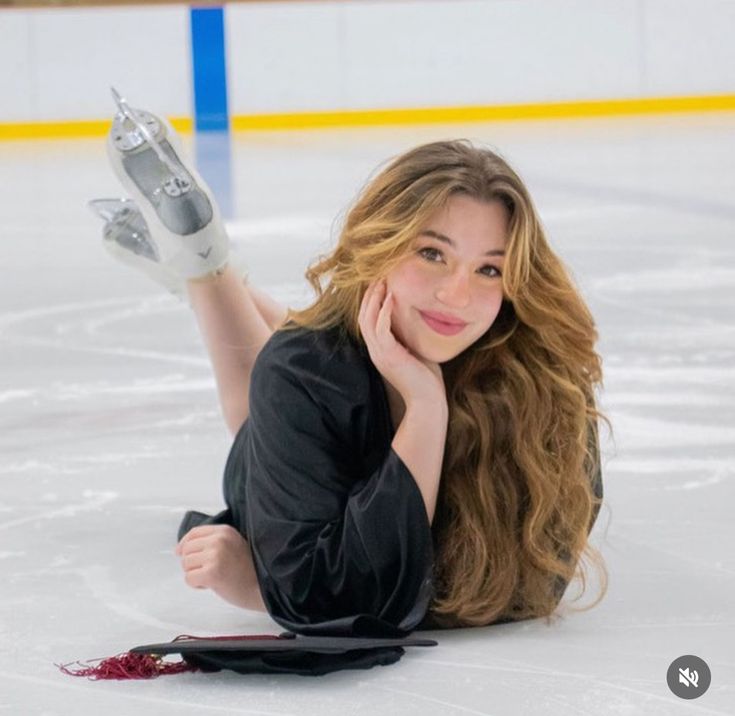 a woman laying on the ice with her legs crossed