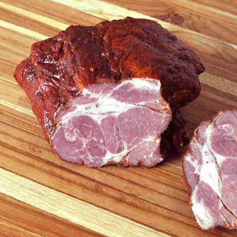 two pieces of meat sitting on top of a wooden cutting board