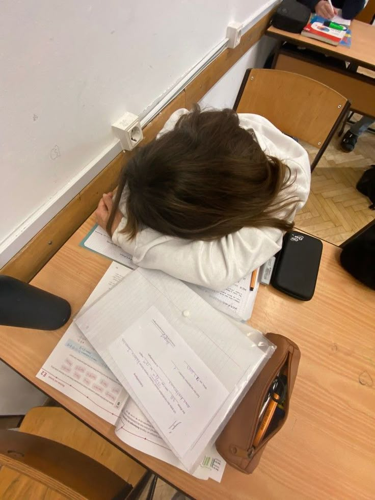 a person sitting at a desk with papers on it