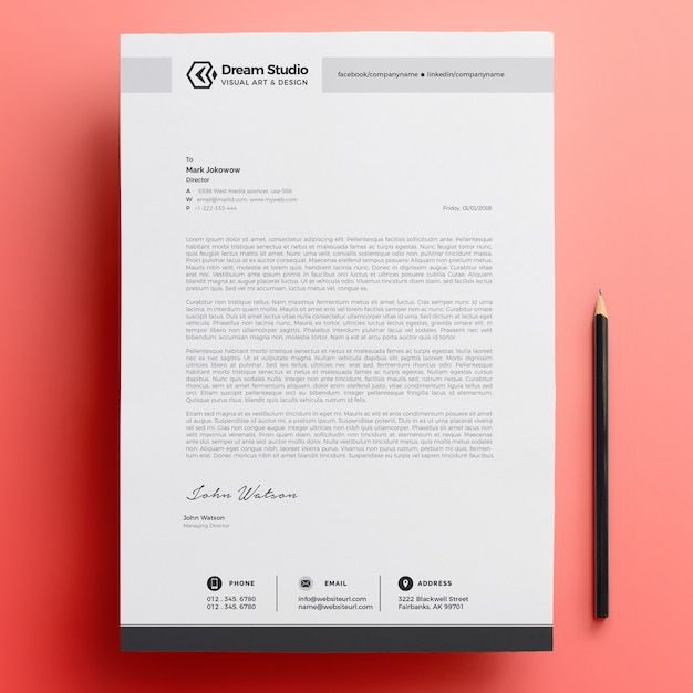 a professional letterhead is displayed on a pink background with a black pen and pencil