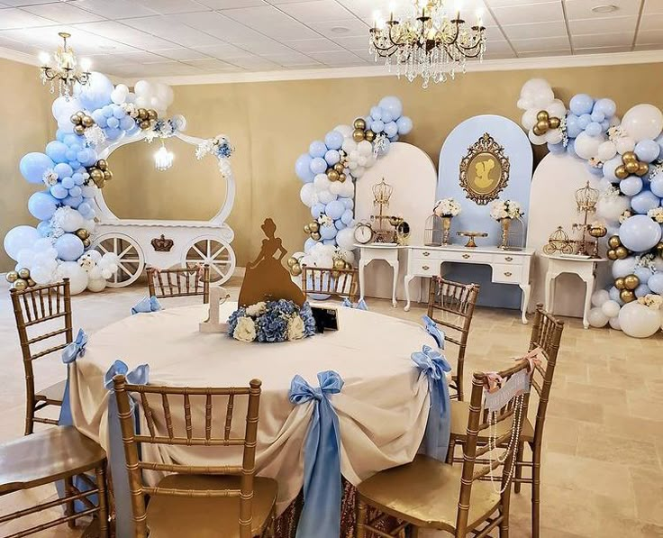 a room filled with tables and chairs covered in blue and white balloons on top of them