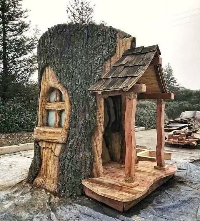 a tree stump with a house built into it