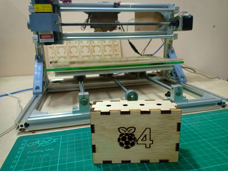 a wooden block with the number 4 on it next to a machine that is cutting paper