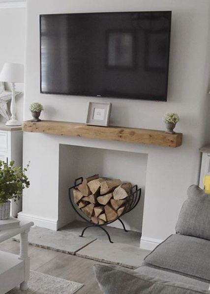 a flat screen tv mounted above a fireplace in a living room