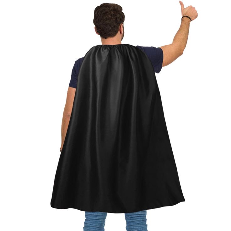 a man wearing a black cape and pointing to the side with his hand in the air