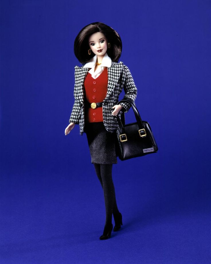 a barbie doll holding a black handbag