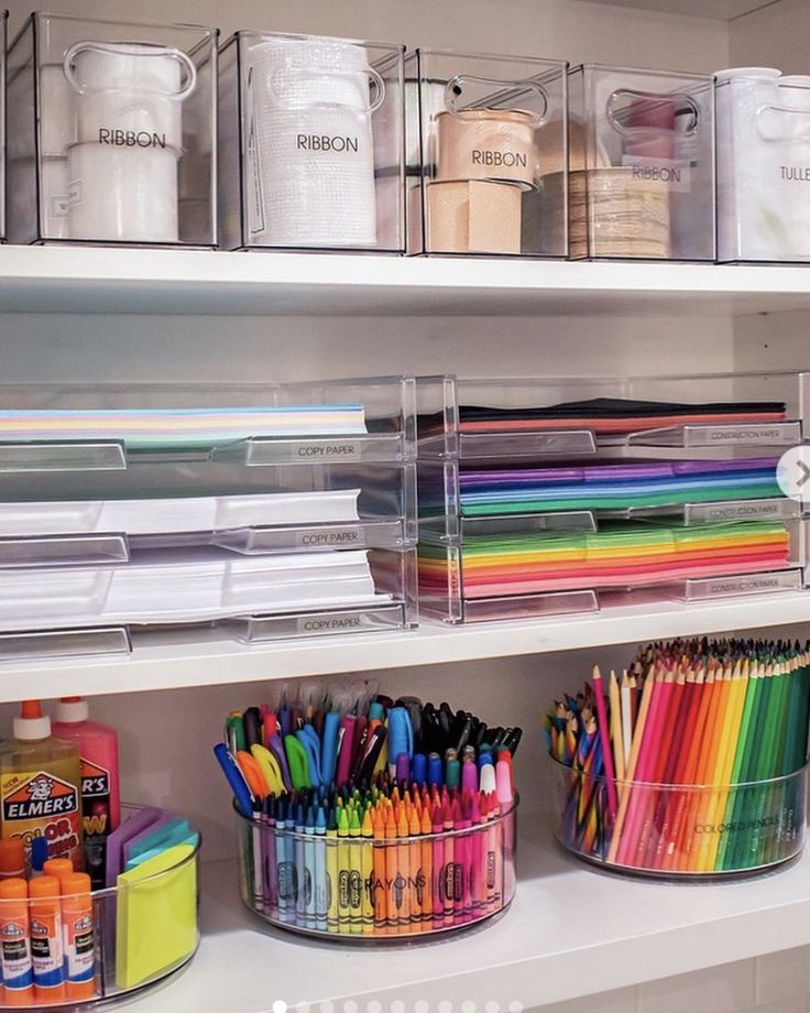 the shelves are filled with lots of different colored markers and pencils in plastic containers