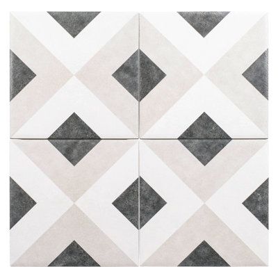 a white and grey tile with black squares on it's sides, in the shape of diamonds