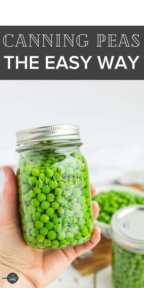 a hand holding a jar filled with peas and the text canning peas the easy way