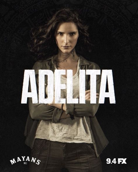 a woman standing in front of a black background with the words adelita on it