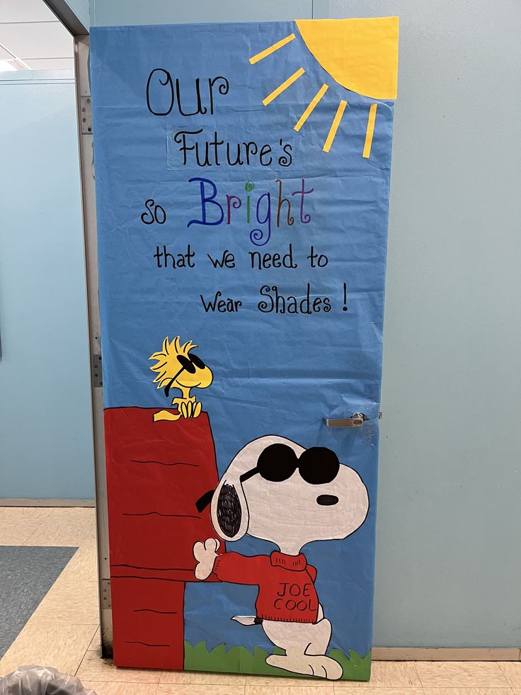 a door decorated with a snoopy cartoon character and the words our future is so bright that we need to wear shades