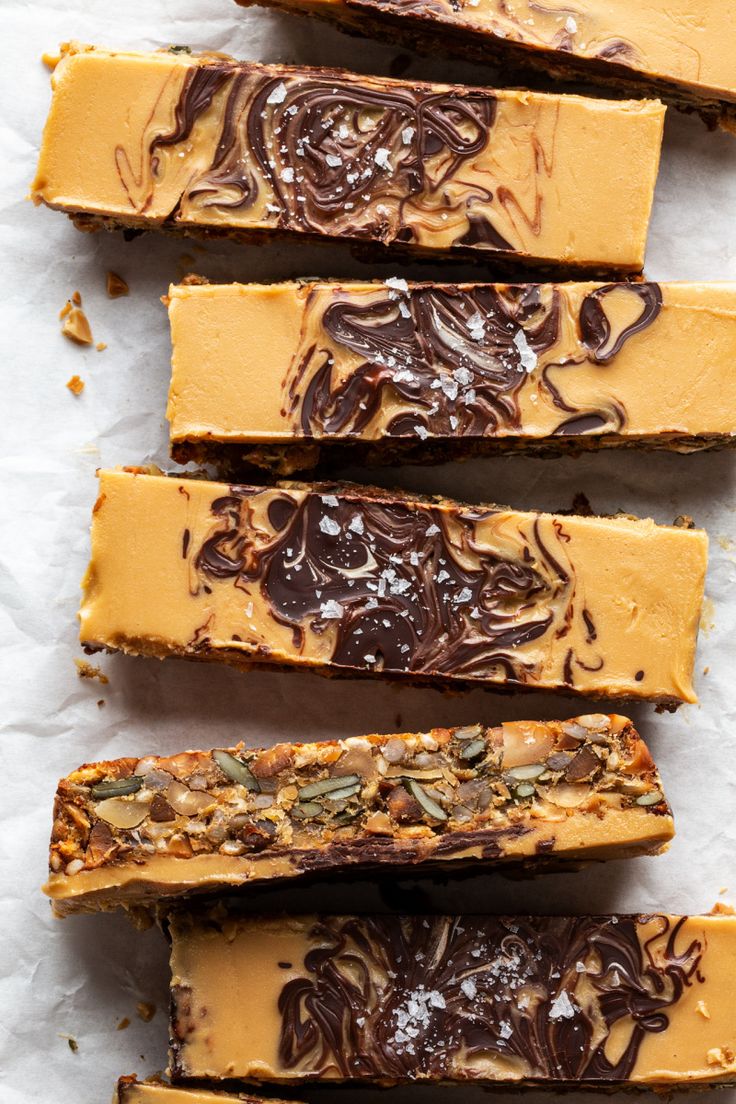 five pieces of chocolate caramel cheesecake on parchment paper