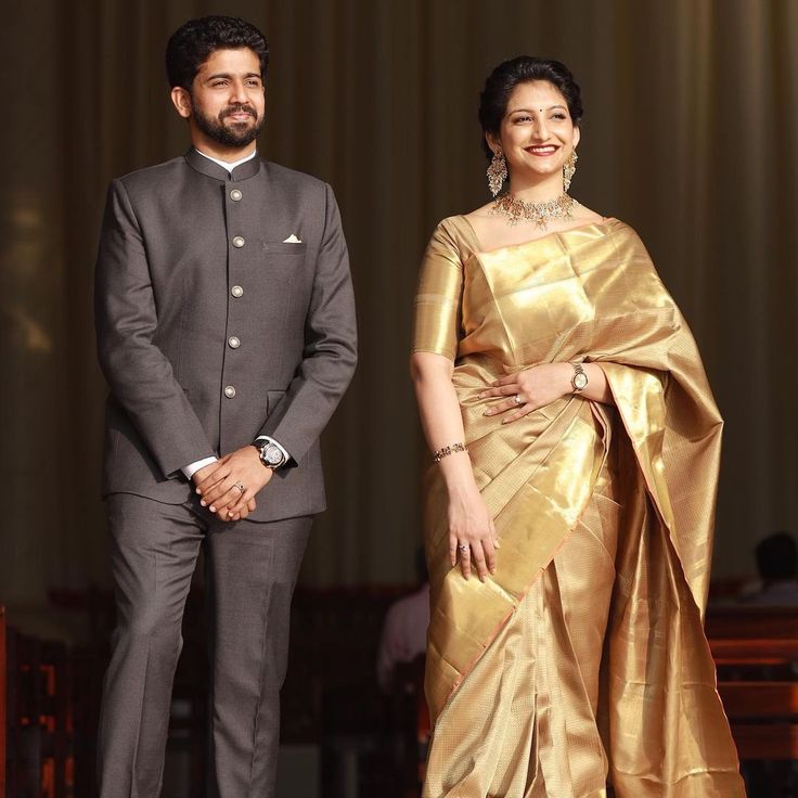 a man and woman standing next to each other on a stage wearing formal wear clothing