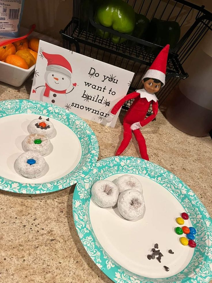 two plates with doughnuts on them and an elf next to the plate that says do not want to build snowmen