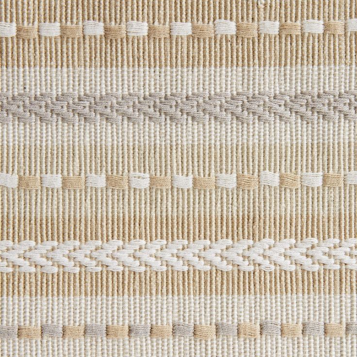 an upholstered beige and white striped rug