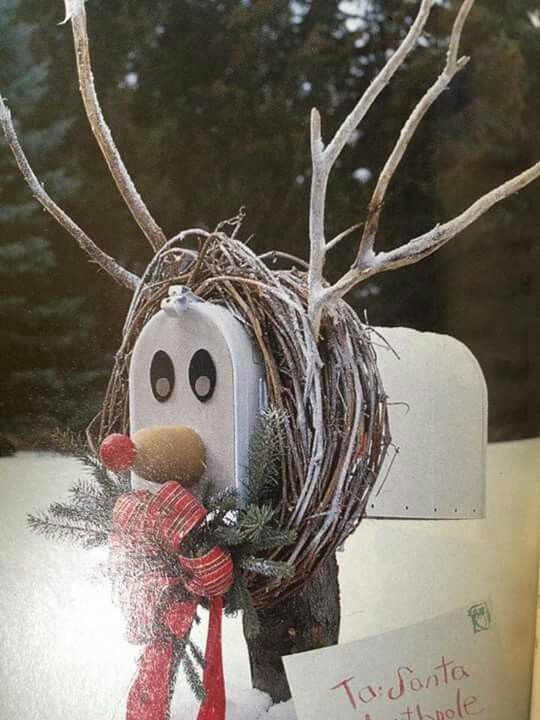 a close up of a mailbox decorated with branches