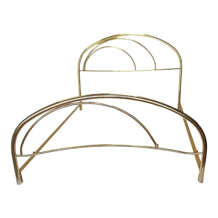 a gold metal bed frame with two circular rails on each side and one curved headboard