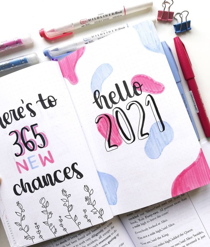 an open notebook with new year's numbers on it and some markers next to it