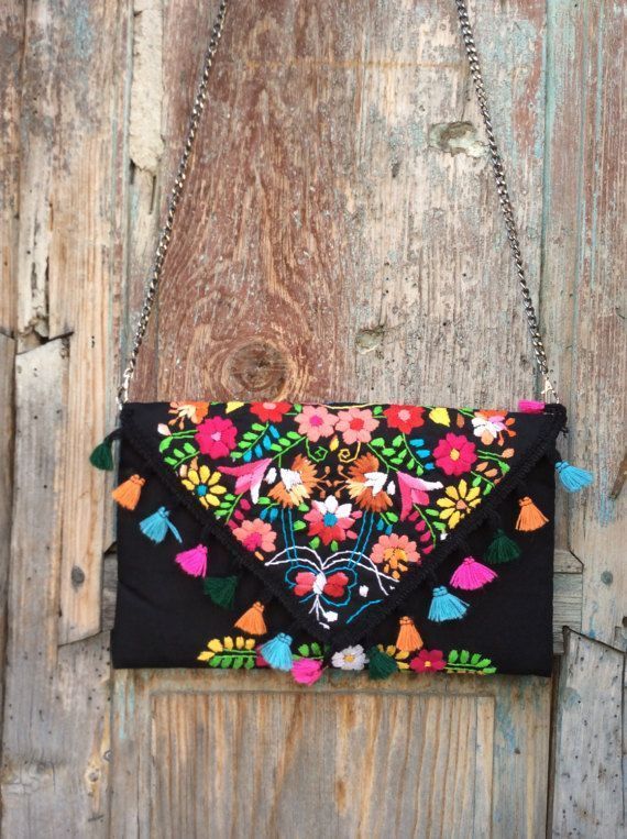 an embroidered purse hanging on a wooden door