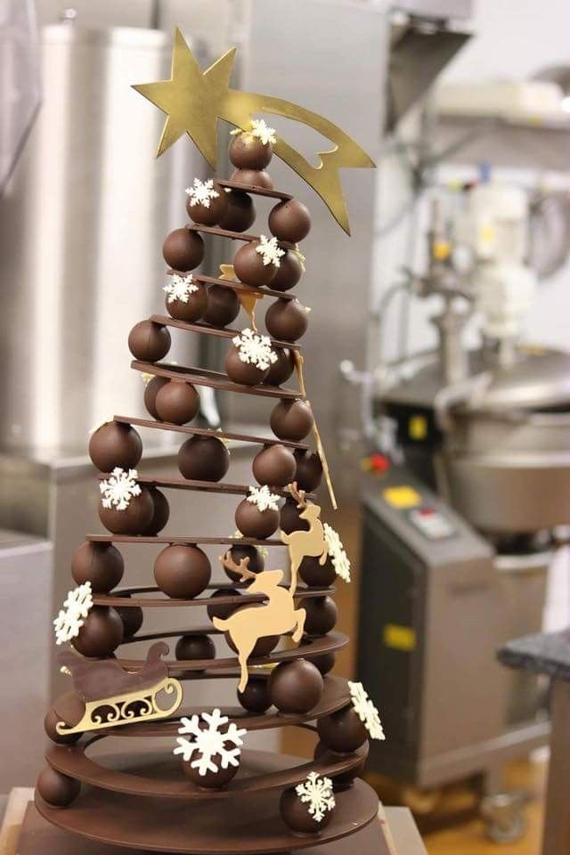 a chocolate christmas tree with white and gold decorations