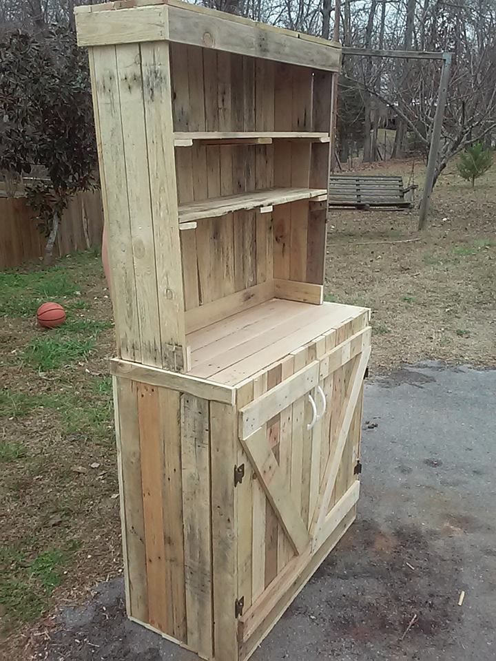 a wooden cabinet sitting in the middle of a yard