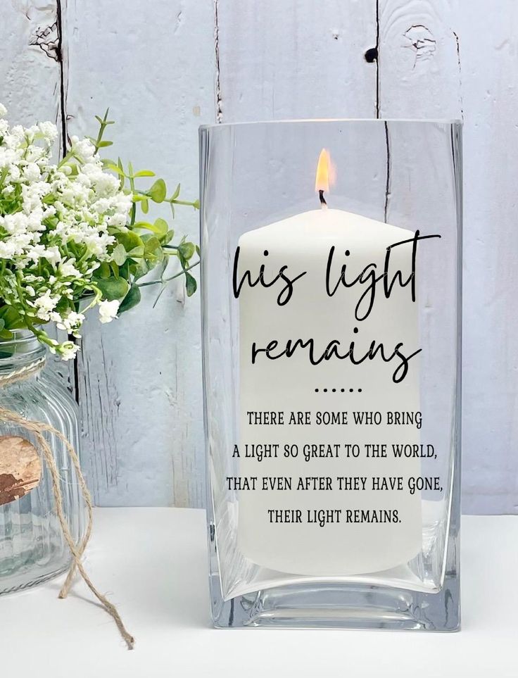 a candle that is sitting next to a vase with flowers in it and the words, this light remains are some who bring a light to the world