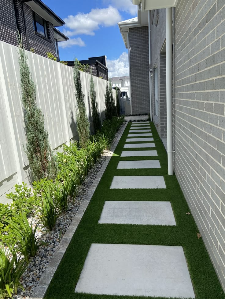 a walkway made out of artificial grass between two buildings