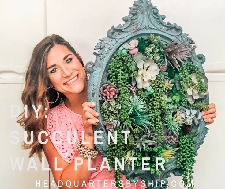 a woman holding up a wreath with succulents on it and the words diy succulent wall planter