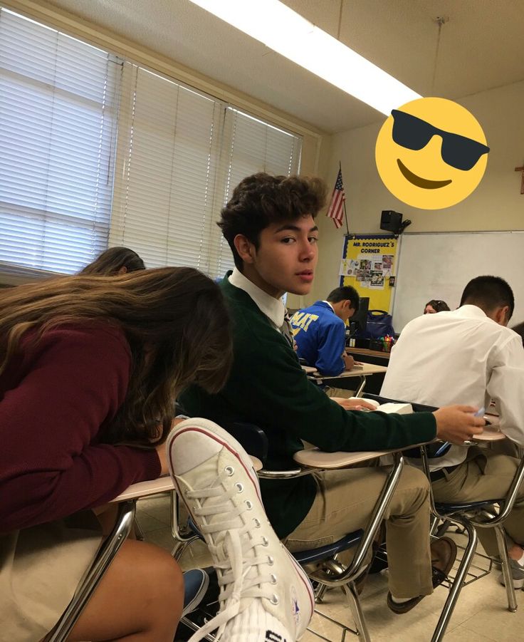 a group of young people sitting at desks in a classroom