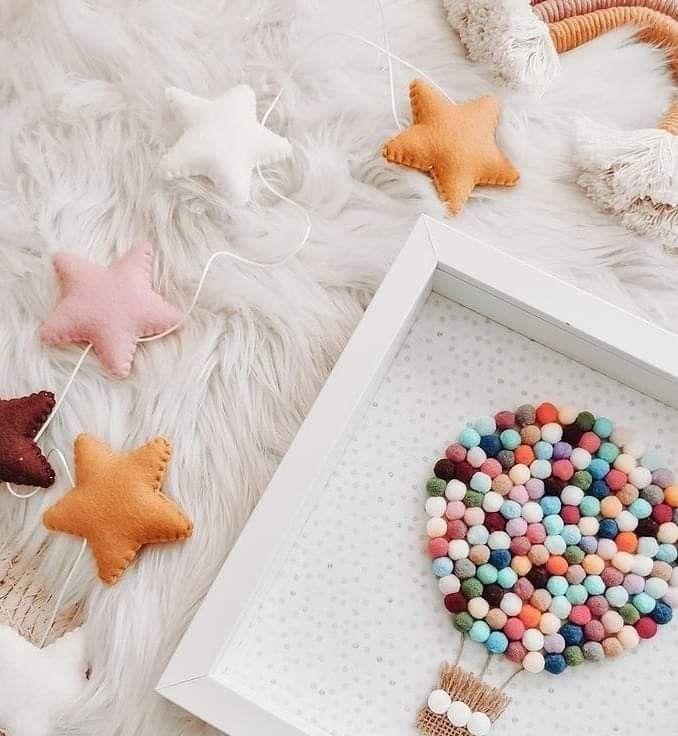 a white box filled with star shaped candies next to other small stars and decorations