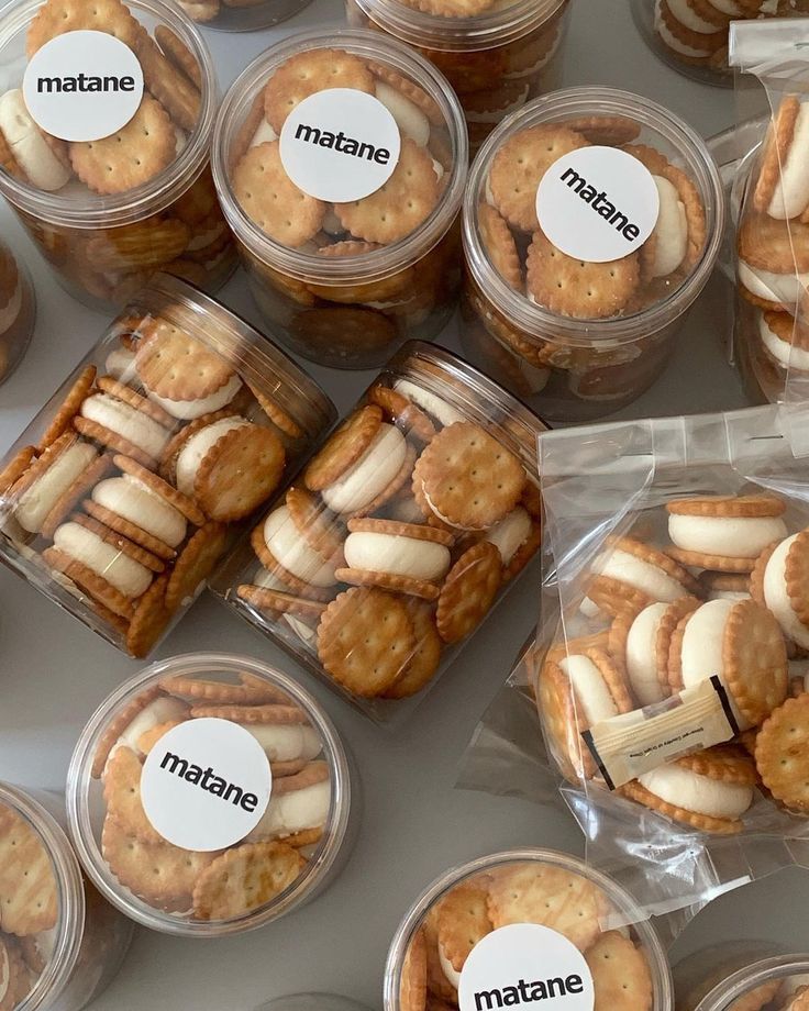 many small plastic containers filled with crackers and cookies