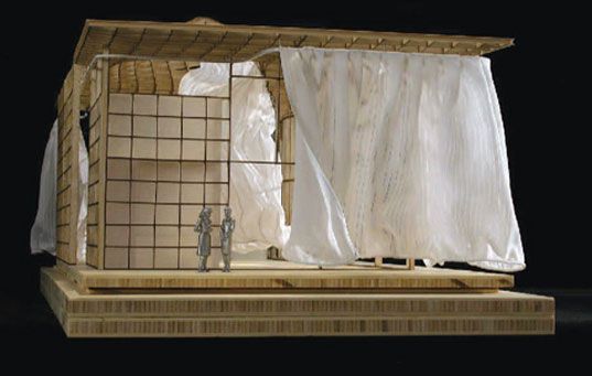 a model of a house made out of wood and white fabric on top of it