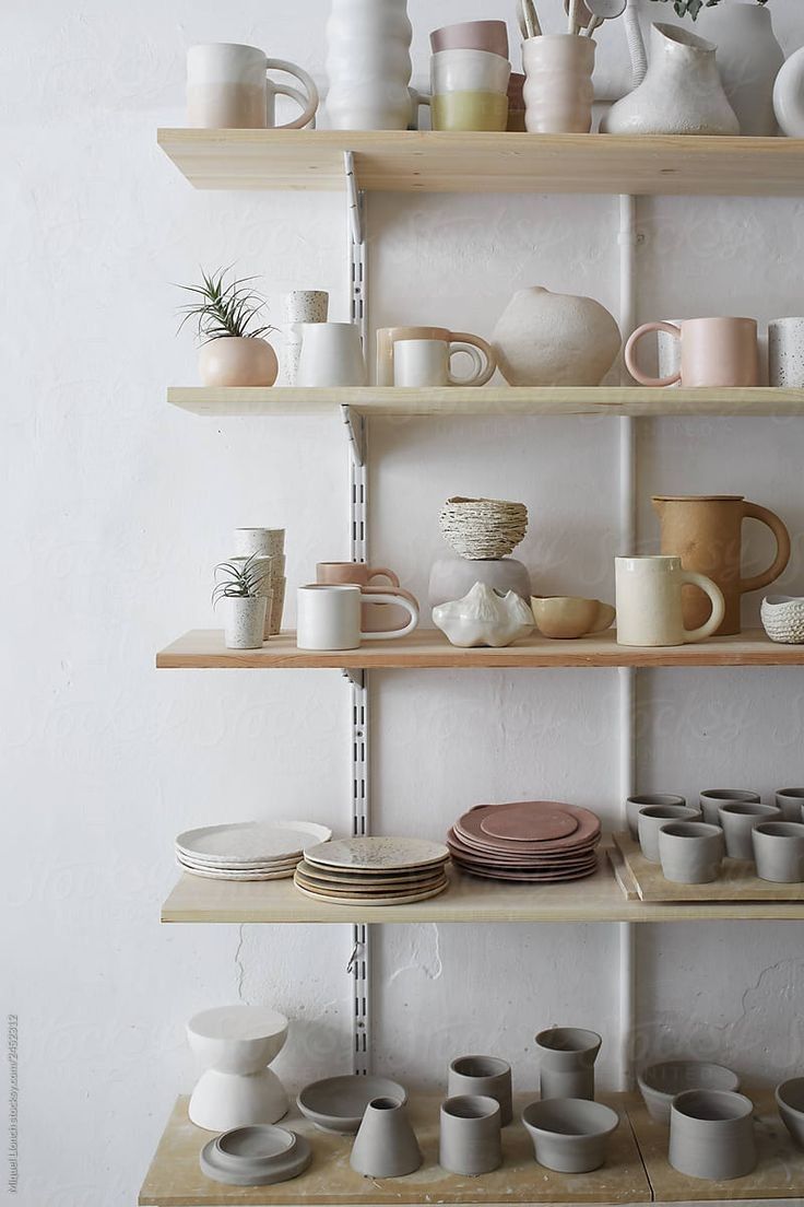 the shelves are filled with different types of pottery