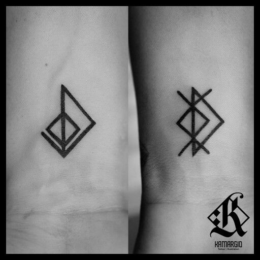 two small tattoos on the wrist, one with an arrow and another with a diamond