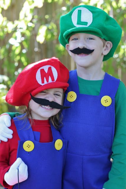 two children dressed up as mario and luigi from mario bros are smiling for the camera