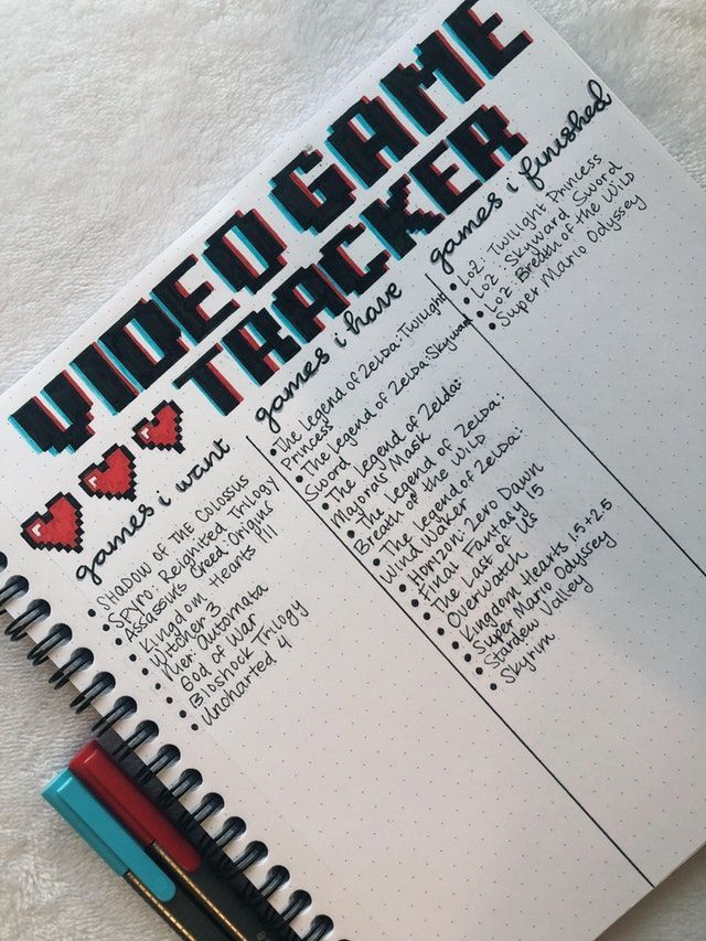 an open notebook with the words under game tracker written in red and black on it