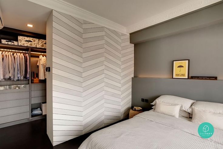 a white bed sitting in a bedroom next to a closet