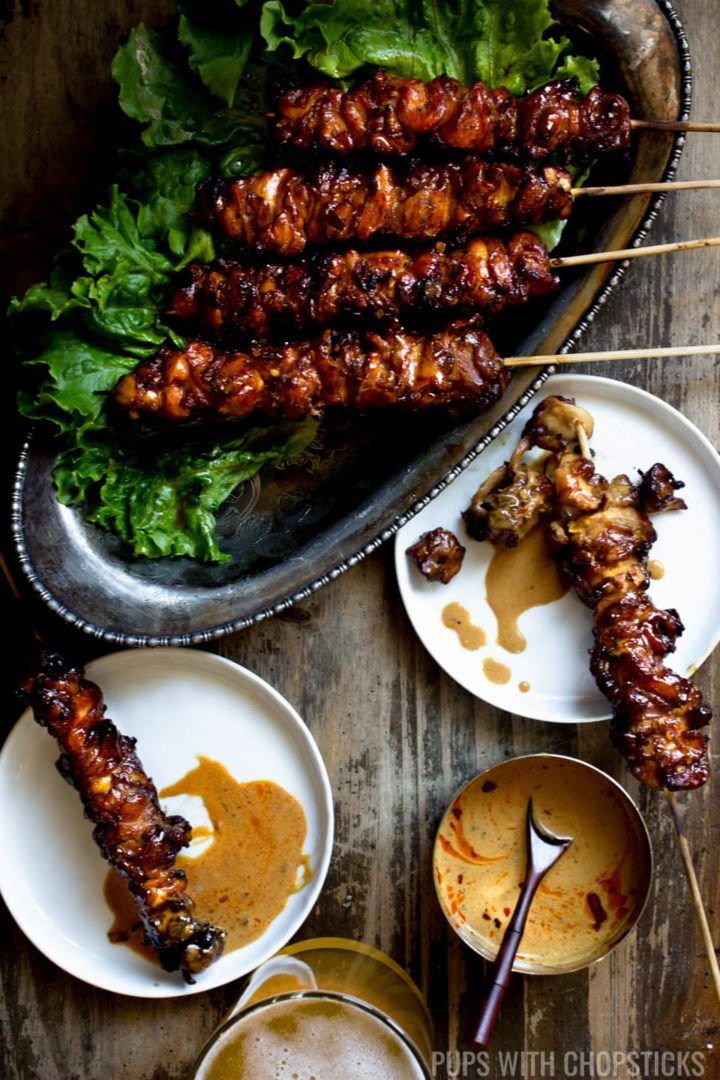 skewers of satay with dipping sauces on the side