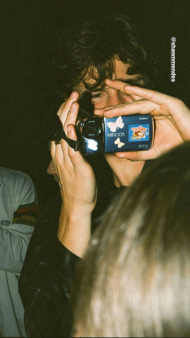 a man holding up his cell phone to take a picture