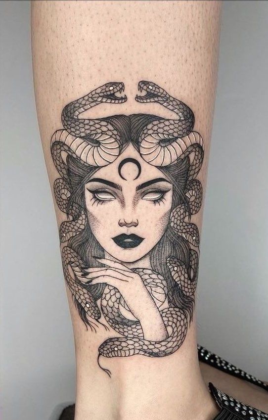 a woman's leg with a snake on it and the words, i am not sure