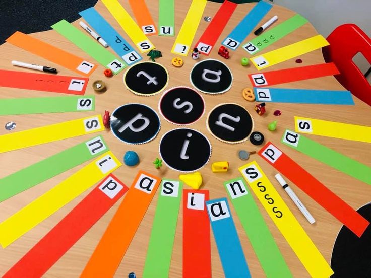 a wooden table topped with lots of different types of letters and numbers on top of it