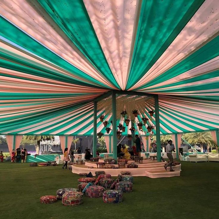 the inside of a large tent with people sitting under it