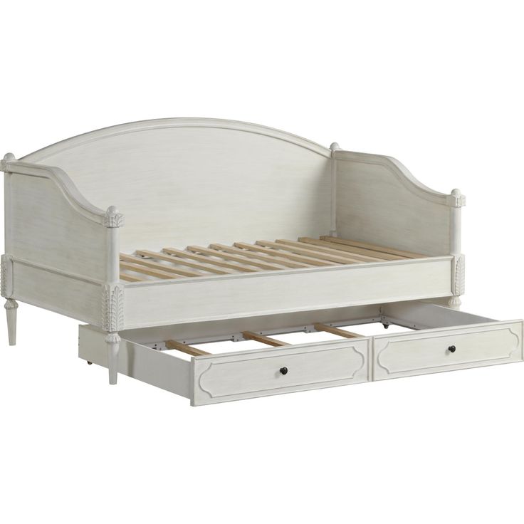 a white bed with drawers underneath it and an open drawer under the bed headboard