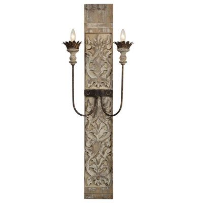 an old fashioned wall light with two lights on each side and one candle holder in the middle